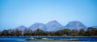 Sheer pink granite mountains overlook the calm, crystal clear water of Oyster Bay | Andrew Wilson